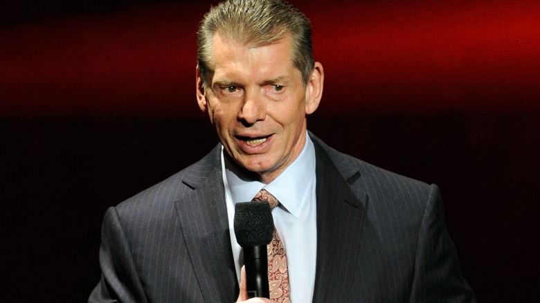 Vince McMahon holding a microphone