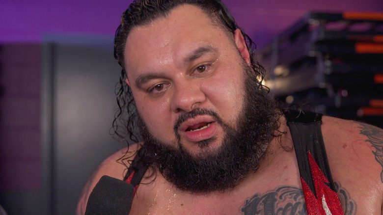 Bronson Reed being interviewed backstage at a WWE show
