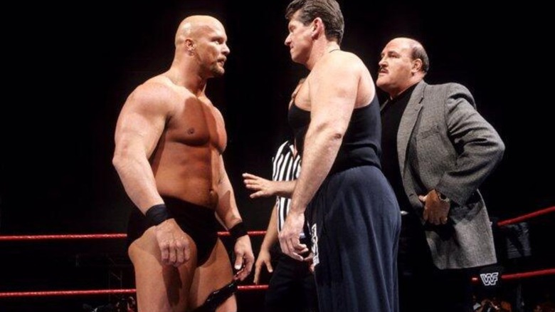 "Stone Cold" Steve Austin and Mr. McMahon stare each other down in the ring before a match on WWF programming.