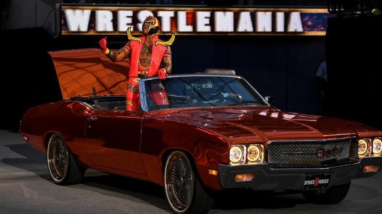 Rey Mysterio rides in a low rider in honor of Eddie Guerrero during a WrestleMania entrance.