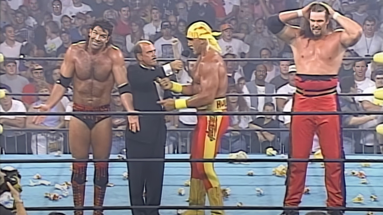 Gen Okerlund interviews Hulk Hogan with Scott Hall and Kevin Nash in the ring at WCW Bash at the Beach 1996.