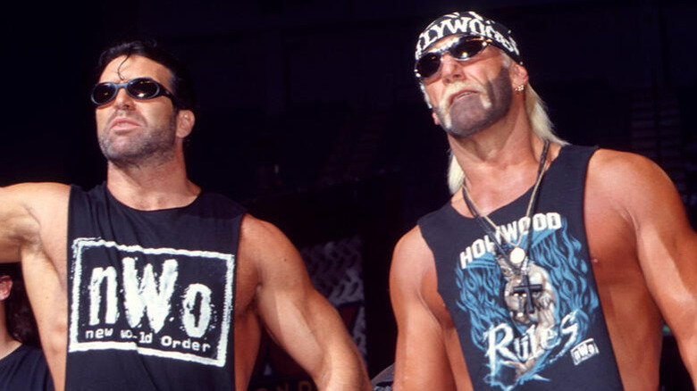 Hulk Hogan stands beside Scott Hall during a post-match angle on WCW programming.