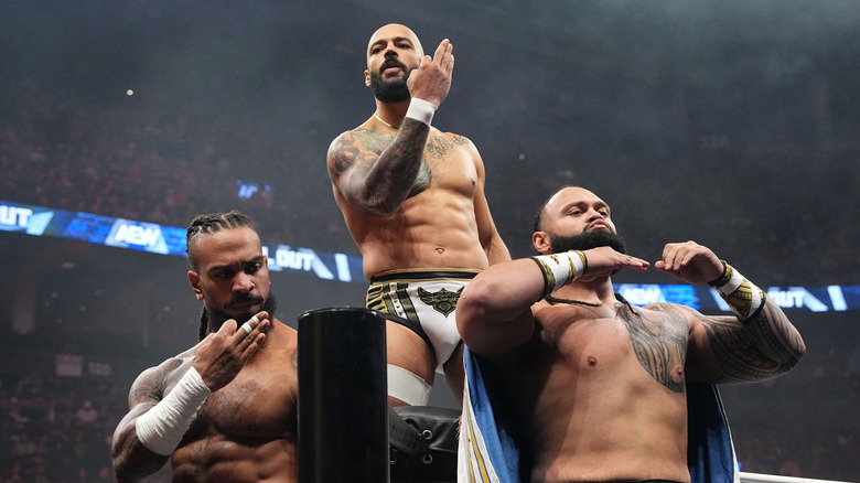 Bishop Kaun, Ricochet, and Toa Liona pose in the corner before their match against the Hurt Syndicate at AEW All Out.