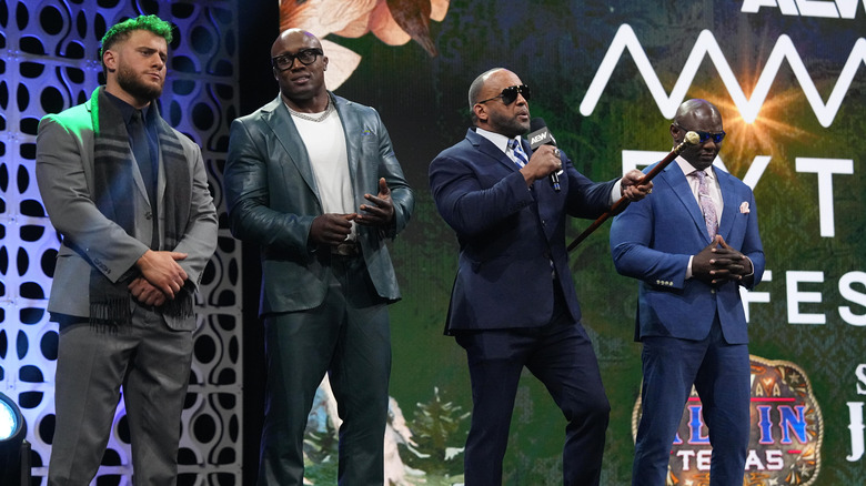 MJF, Bobby Lashley, and Shelton Benjamin stand on the stage during 