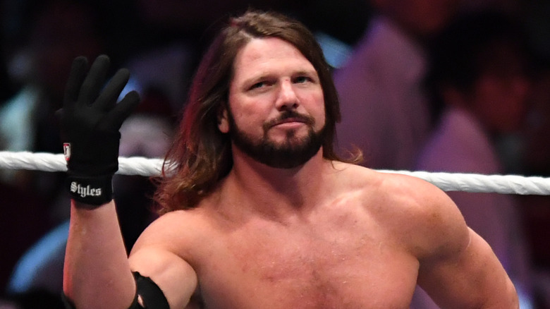 AJ Styles holds up his hand