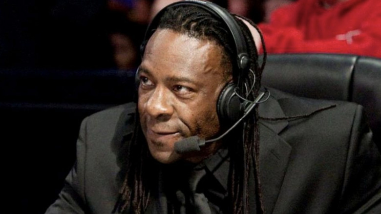 Booker T sitting at the commentary desk