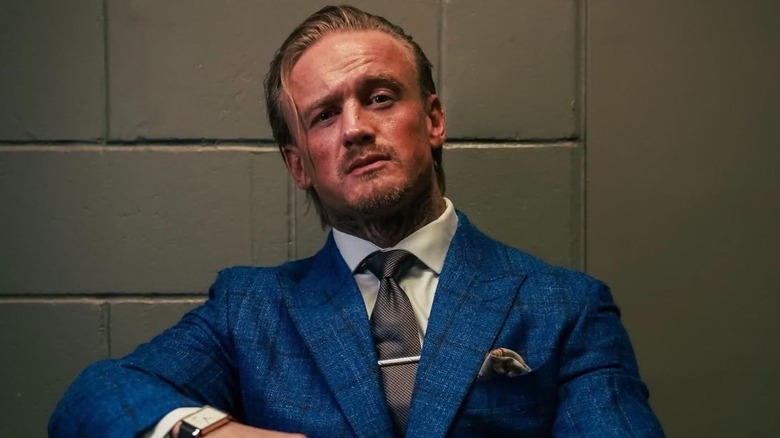 Ilja Dragunov poses for a backstage photo shoot with AEW after his WrestleDream apperance