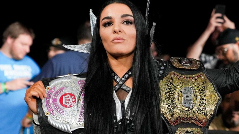 Deonna Purrazzo carries her title belts