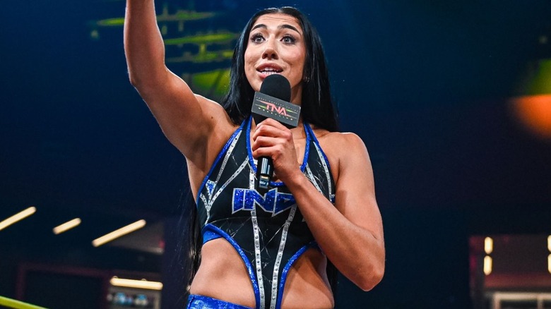 Indi Hartwell holding a microphone