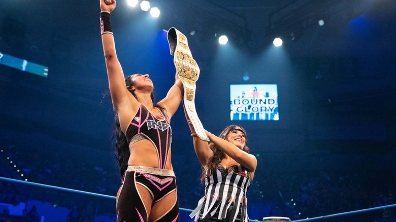 Indi Hartwell celebrates with the Knockouts World title alongside Mickie James