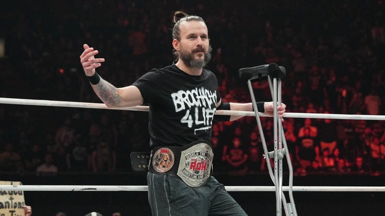 Adam Cole shows up in the ring with crutches