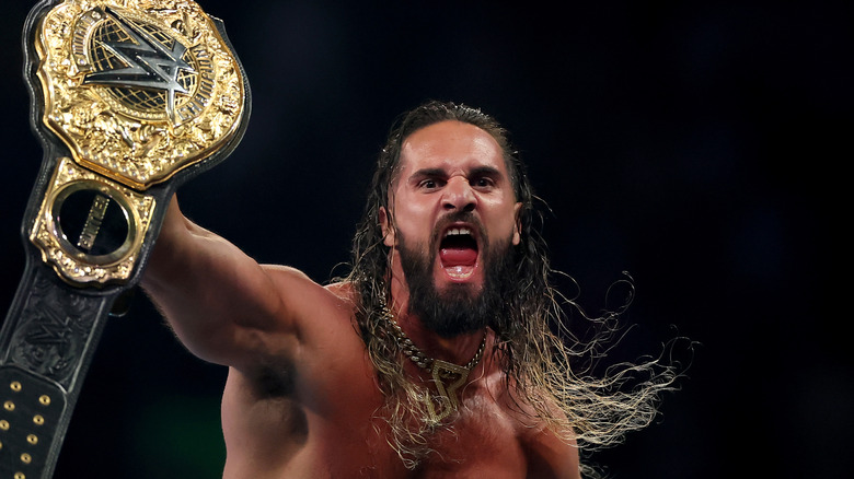 Seth Rollins celebrating after winning the WWE World Heavyweight Championship at SummerSlam 2025.