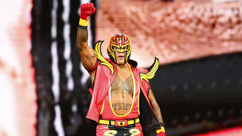 Rey Mysterio makes an entrance with a raised fist