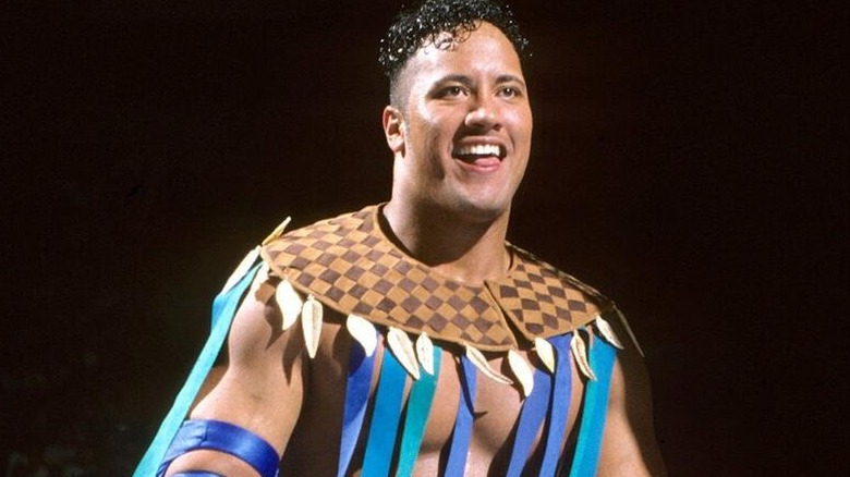 The Rock debuts as Rocky Maivia in a WWF ring before a match.