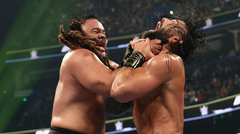 Jacob Fatu puts World Heavyweight Champion Roman Reigns in the Tongan Death Grip in the ring during their title match at WWE Backlash 2026.