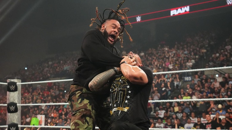 Jacob Fatu locks in the Tongan Death Grip on Roman Reigns in the ring during an episode of 
