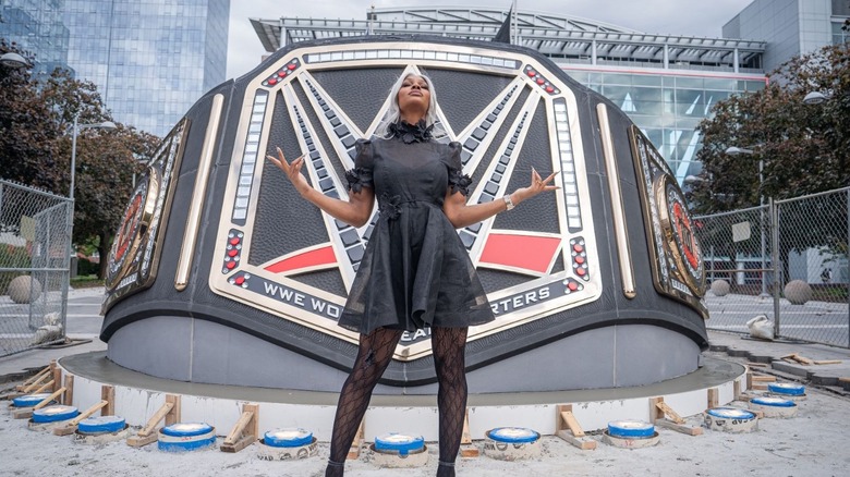 Jade Cargill stands outside of an oversized title belt at WWE Headquarters.