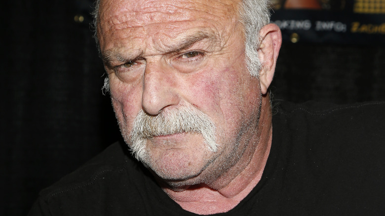 Jake Roberts posing at a press event 
