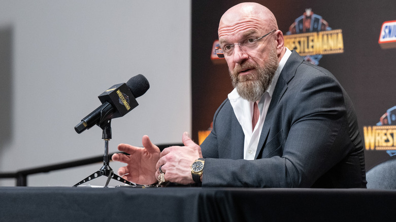 Triple H, wearing glasses and speaking