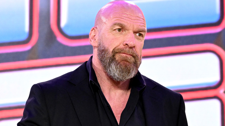Triple H is wearing a black blazer