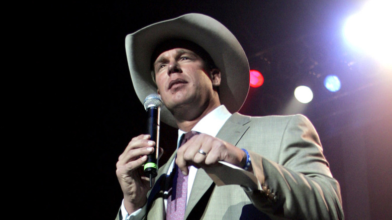 JBL, hat on, mic in hand