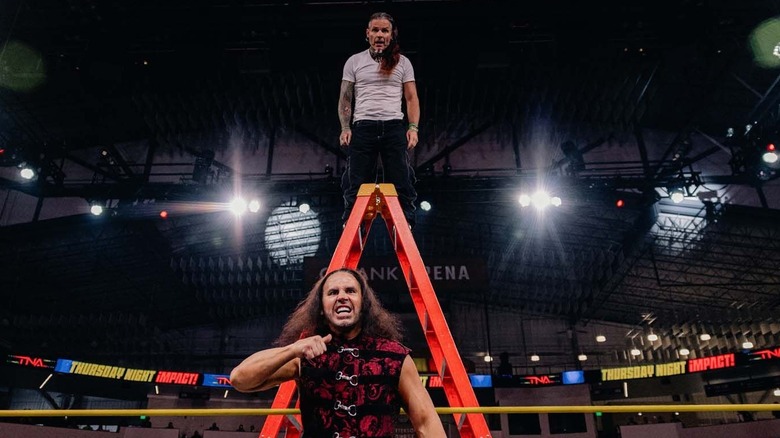 Jeff (standing at the top of the ladder) and his brother Matt (on the bottom in the ring) await their challengers