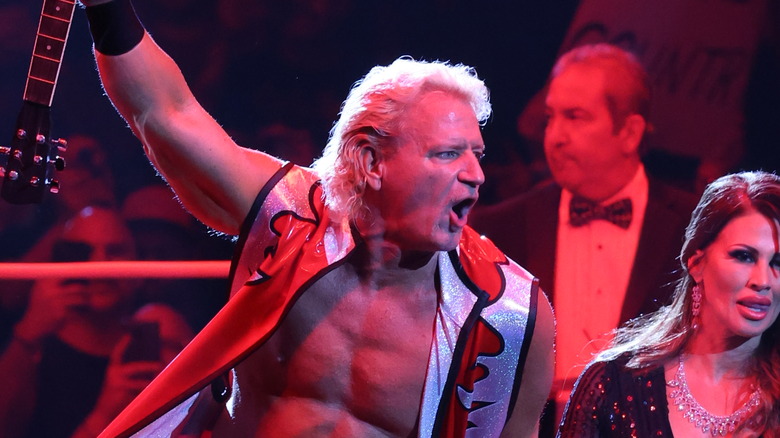 Jeff Jarrett poses with his guitar and wife, Karen Jarrett