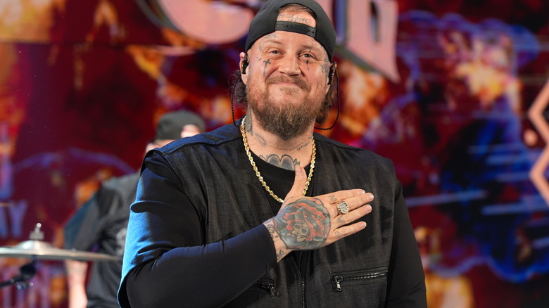 Jelly Roll pats his chest as he makes his WWE appearance.
