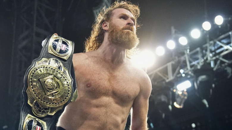 Sami Zayn holding the Intercontinental Championship