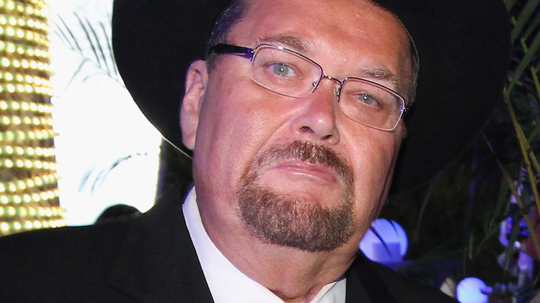 Jim Ross with glasses on, looking at the camera