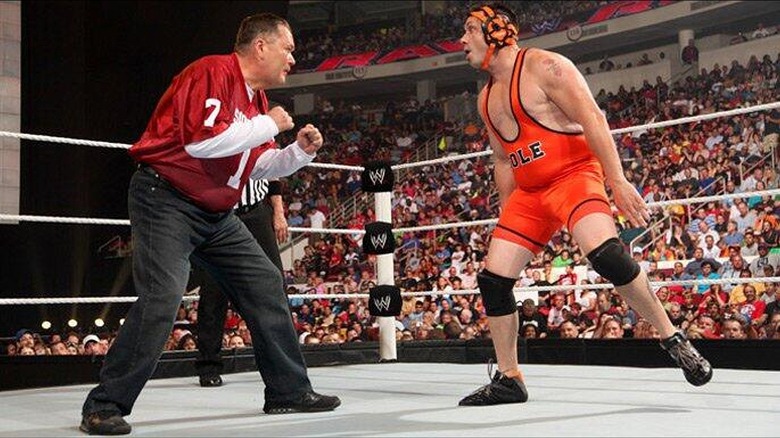 Jim Ross standing off against Michael Cole during an episode of 