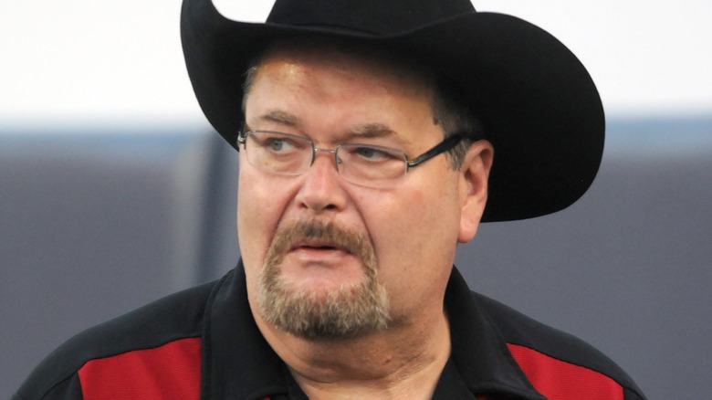 Jim Ross wearing a red and black shirt