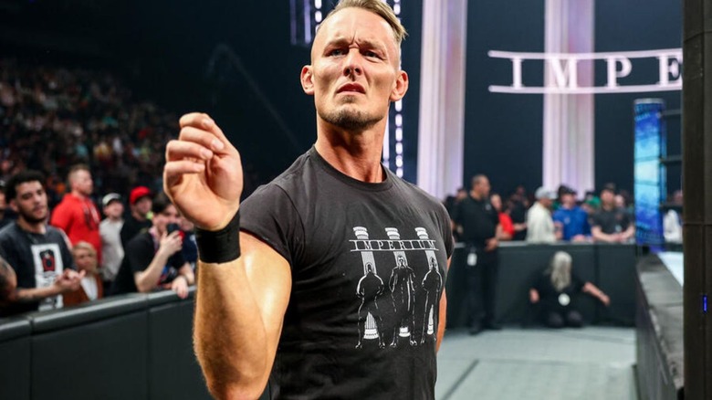 Ludwig Kaiser gestures ringside during an Imperium match on an episode of WWE programming.
