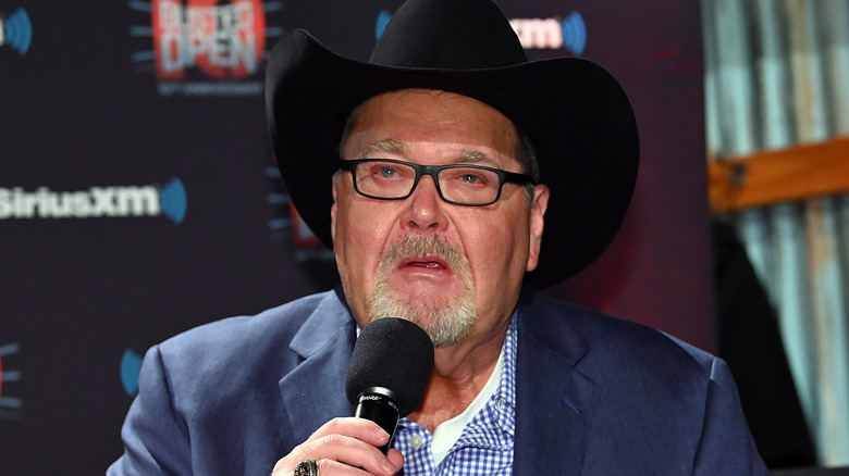 Jim Ross holding microphone