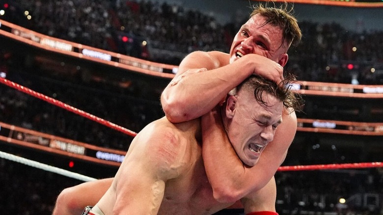 GUNTHER puts John Cena in a hold during Cena's retirement match at WWE Saturday Night's Main Event in December 2025.