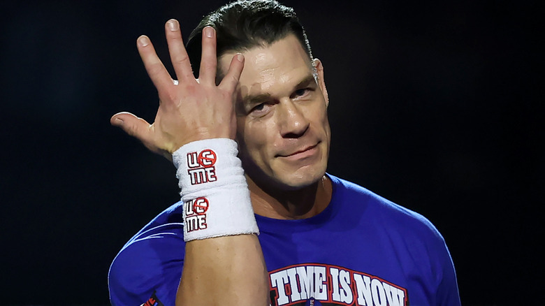 John Cena holding up five fingers