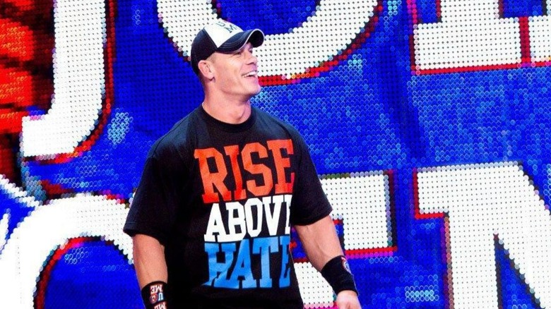 John Cena smiles and looks to the crowd, wearing his 