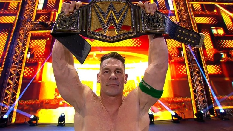 John Cena celebrates with the WWE Championship