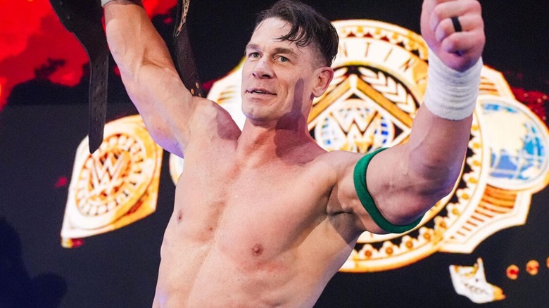 John Cena poses on the stage, Intercontinental Championship in hand, on an episode of "WWE Raw."