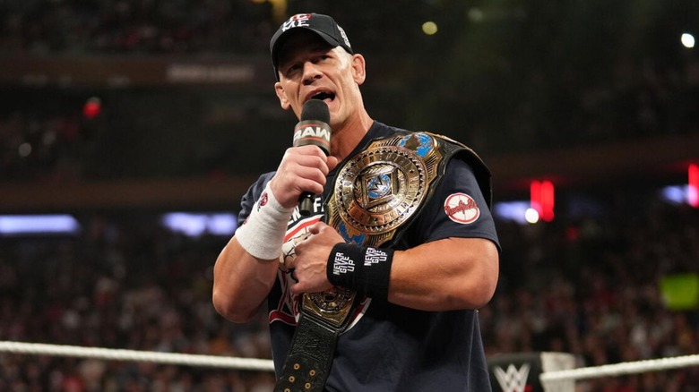 John Cena cuts a promo in the middle of the ring, the Intercontinental Championship on his shoulder, during an episode of 