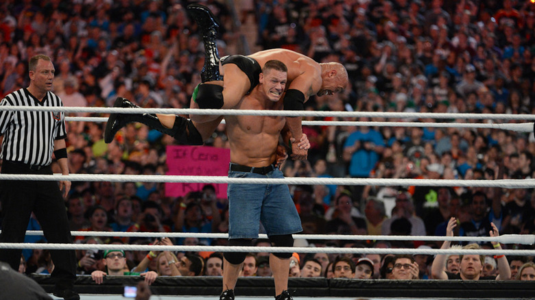 John Cena holding The Rock up on his shoulders