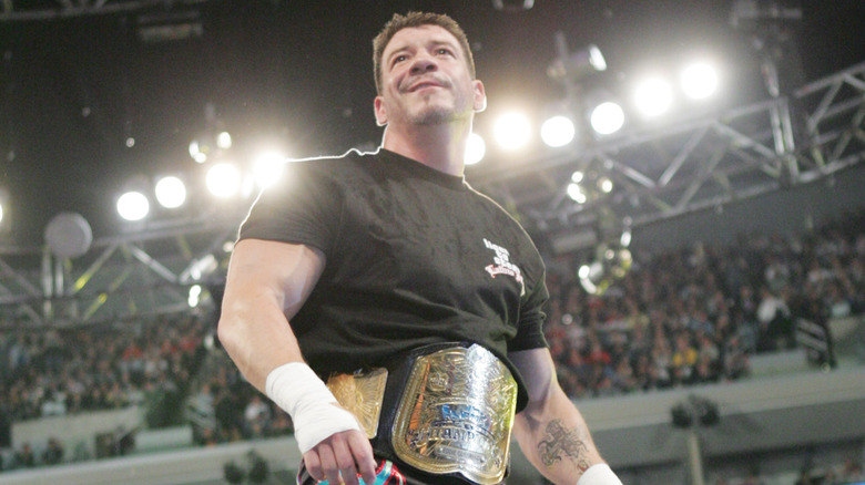 Eddie Guerrero posing at the top of the turnbuckle during his entrance while reigning as one half of the WWE Tag Team Champions.