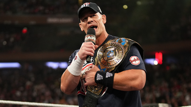 John Cena talking while holding the WWE Intercontinental Championship