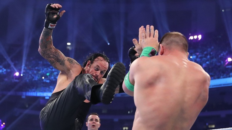 The Undertaker kicking John Cena