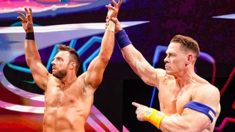 John Cena holds up LA Knight's arm