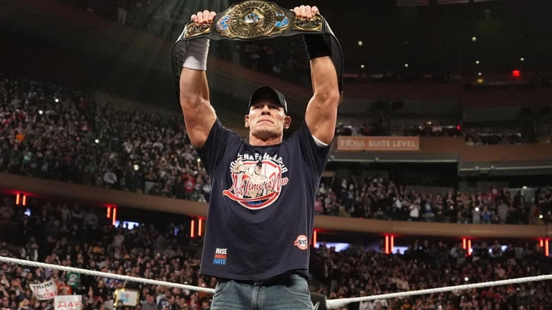 John Cena raises the Intercontinental Championship above his head in the middle of the ring during an episode of 