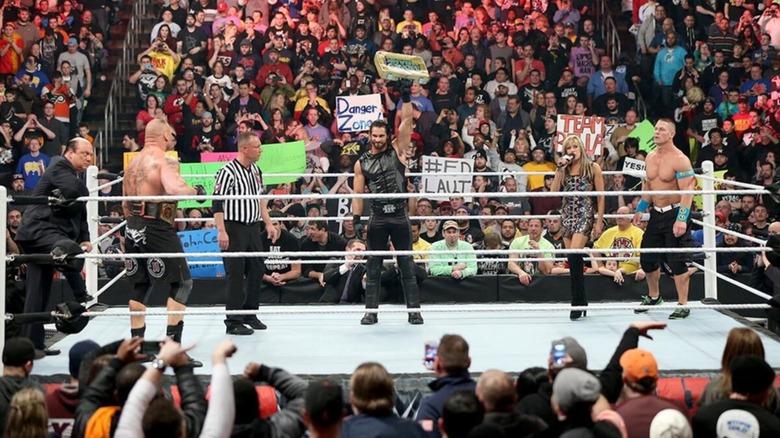 Brock Lesnar, Seth Rollins, and John Cena at the start of their triple threat match