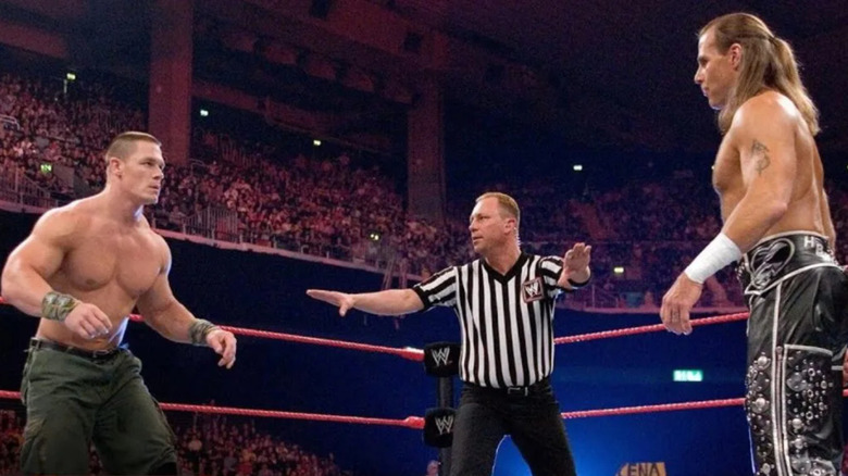 John Cena and Shawn Michaels staring each other from across the ring