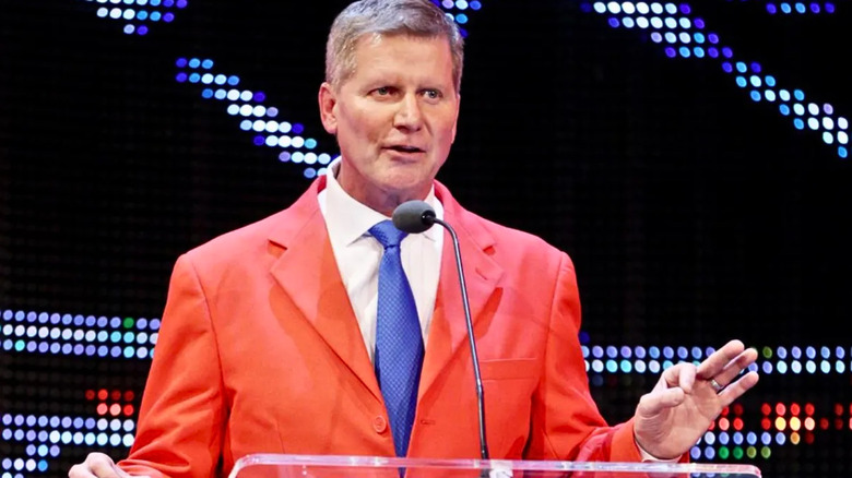 John Laurinaitis wearing a bright red suit