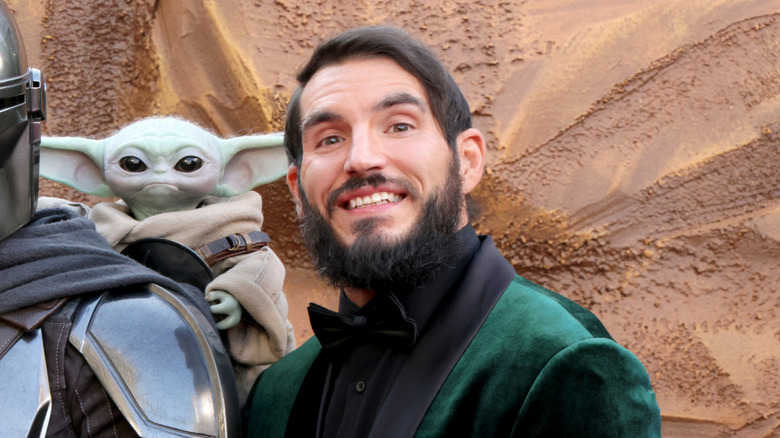 Johnny Gargano either happy to be with Baby Yoda or being held hostage by Baby Yoda